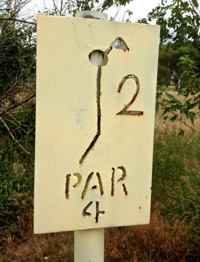Rustic sign designating the dogleg hole #2 at the Hemingford (Nebraska) sand-greens course